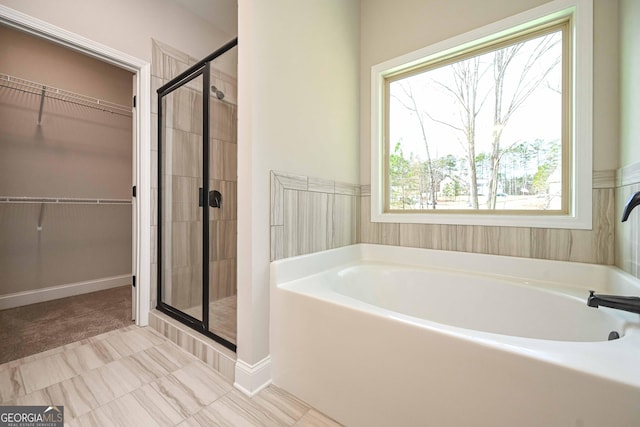 bathroom featuring independent shower and bath