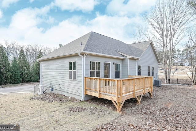 back of property with a wooden deck and central AC unit