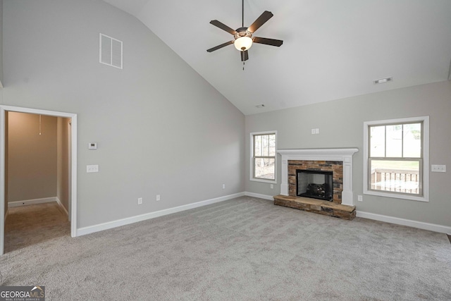 unfurnished living room featuring a fireplace, high vaulted ceiling, light colored carpet, and ceiling fan