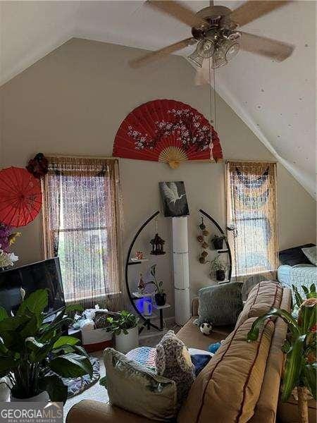 living room featuring lofted ceiling and ceiling fan