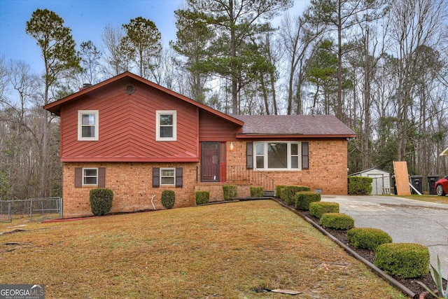 tri-level home with an outbuilding and a front yard