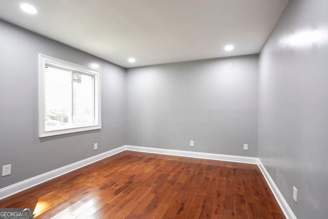 unfurnished room with hardwood / wood-style flooring