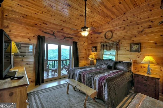 bedroom featuring wooden ceiling, wooden walls, high vaulted ceiling, and access to outside