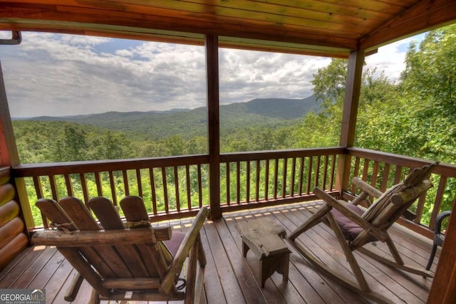 wooden deck featuring a mountain view