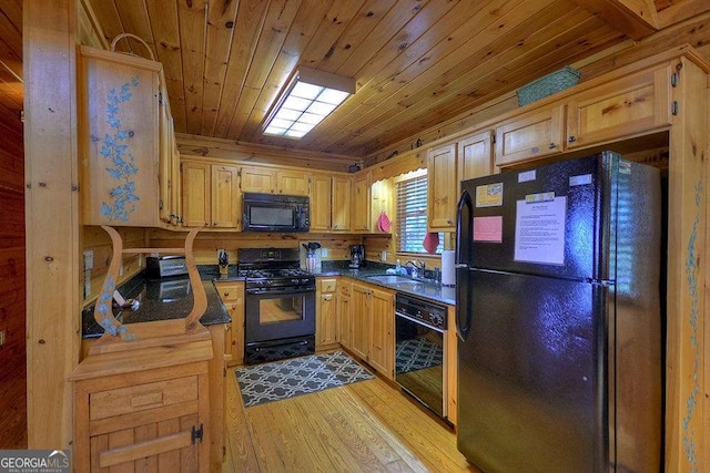 kitchen with sink, wood ceiling, black appliances, and light wood-type flooring