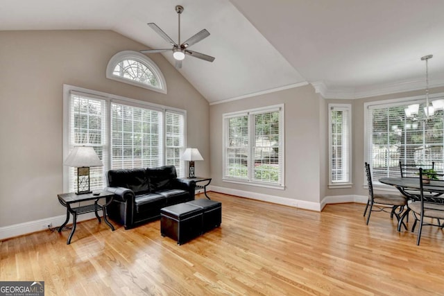 living room featuring high vaulted ceiling, ceiling fan with notable chandelier, and light wood-type flooring