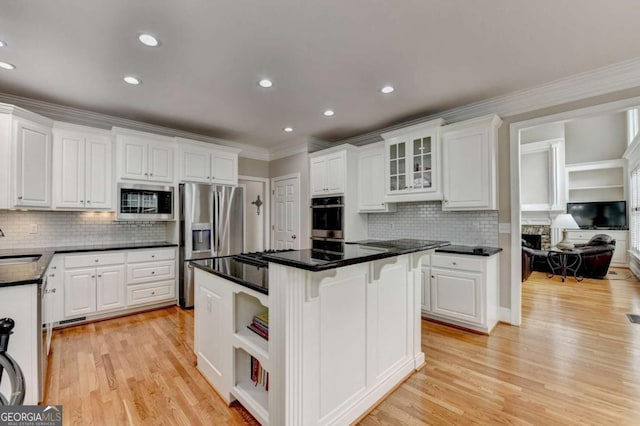 kitchen with white cabinetry, a breakfast bar area, stainless steel appliances, and a center island