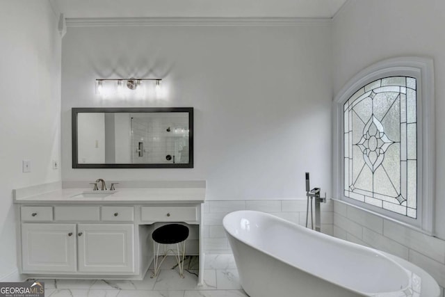 bathroom with vanity, a bath, and crown molding