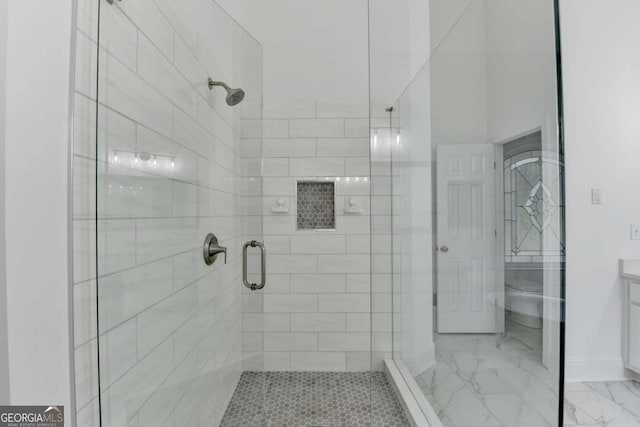 bathroom featuring walk in shower, vanity, and toilet