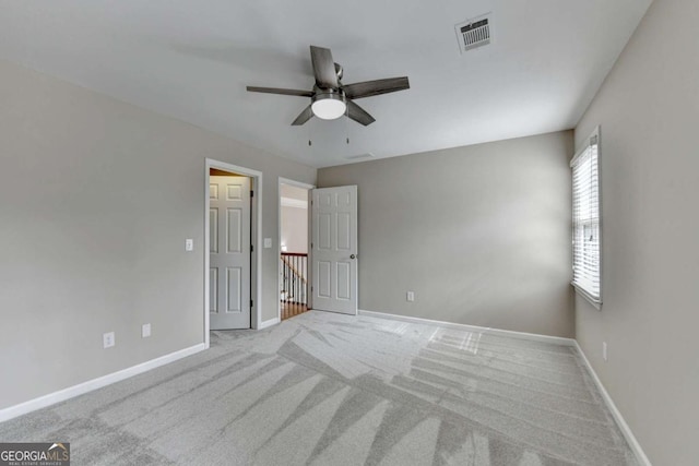 unfurnished bedroom featuring light carpet and ceiling fan