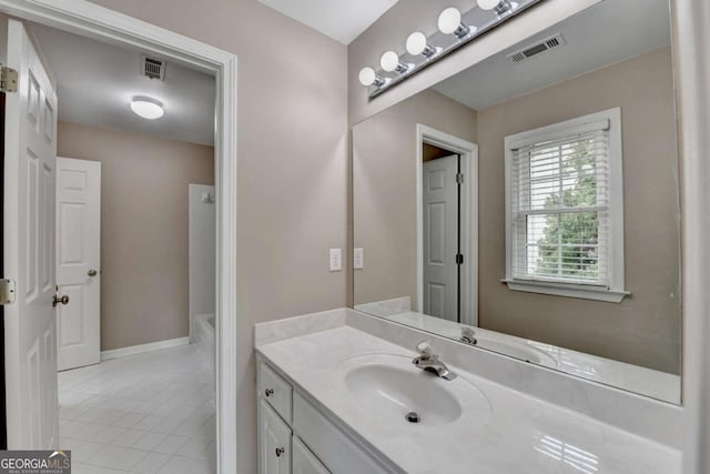 bathroom featuring tile patterned flooring and vanity