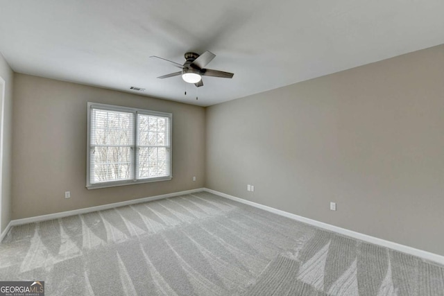 unfurnished room featuring light colored carpet and ceiling fan