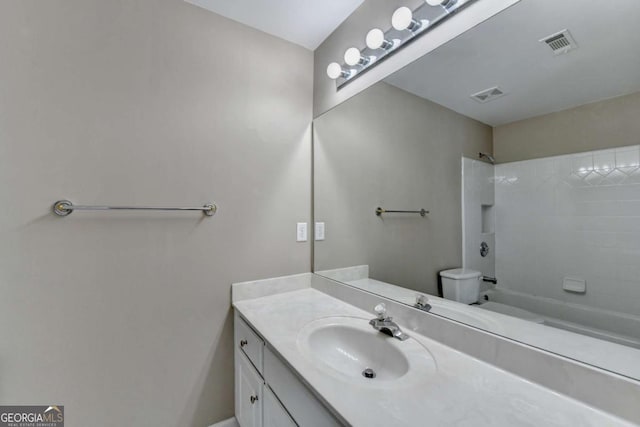 full bathroom with tiled shower / bath combo, vanity, and toilet