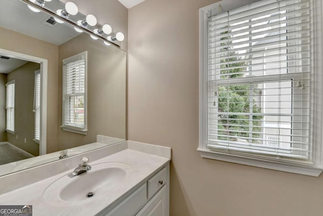 bathroom with vanity and a healthy amount of sunlight