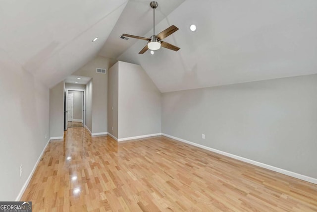 additional living space with ceiling fan, vaulted ceiling, and light wood-type flooring