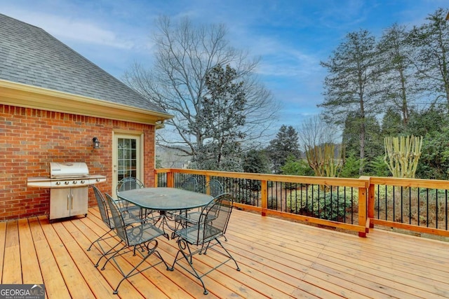 wooden deck featuring a grill