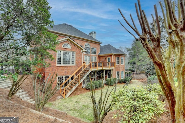 rear view of property featuring a wooden deck