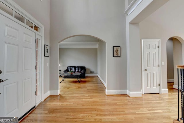 entrance foyer featuring a high ceiling and light wood-type flooring