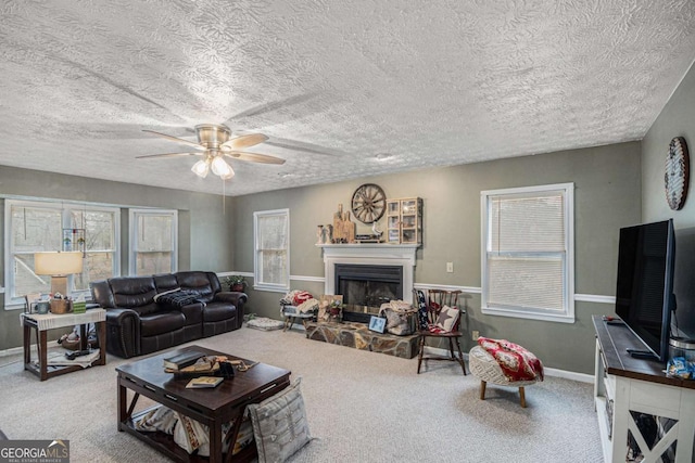 living room featuring a textured ceiling, ceiling fan, and carpet flooring