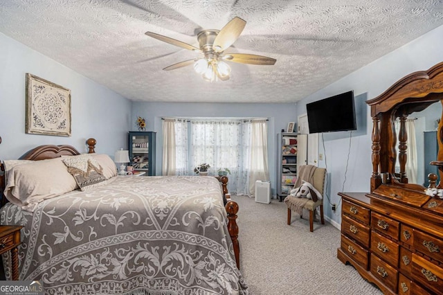 carpeted bedroom with a textured ceiling and ceiling fan