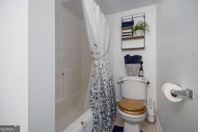 bathroom featuring shower / bath combo and toilet