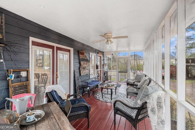 sunroom featuring ceiling fan