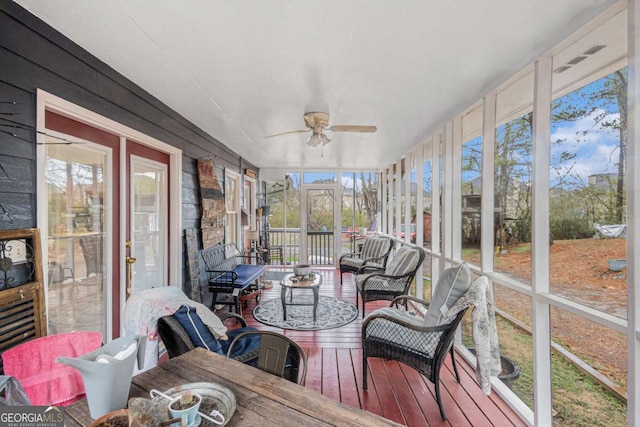 sunroom / solarium featuring ceiling fan