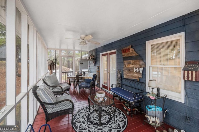 sunroom / solarium featuring ceiling fan