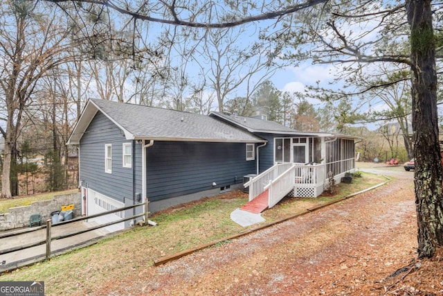 view of front of house featuring a garage and a sunroom