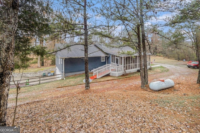 view of front of home with a sunroom