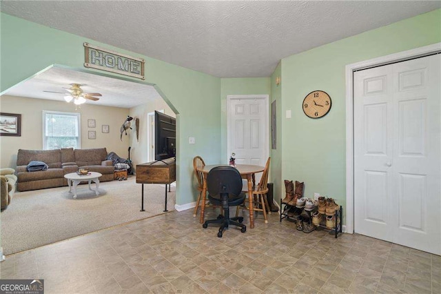 living room featuring light carpet and a textured ceiling