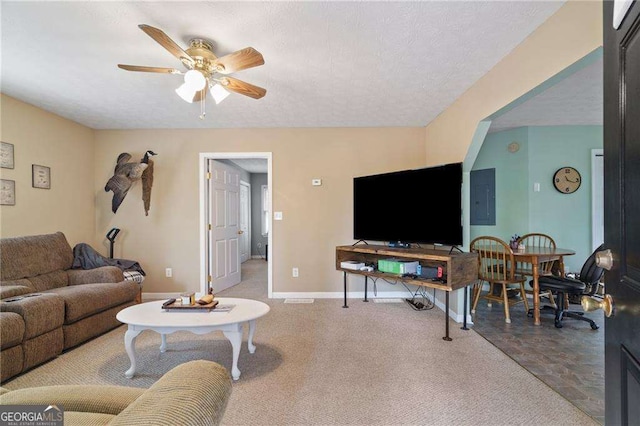 living room with a textured ceiling, electric panel, and ceiling fan