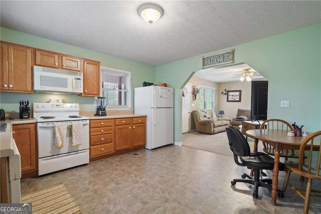 kitchen with white appliances, a textured ceiling, and ceiling fan