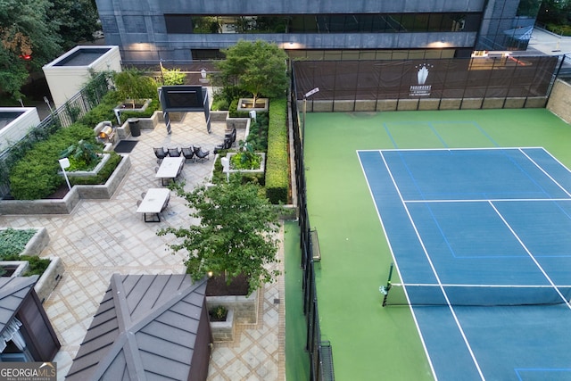 view of sport court featuring fence