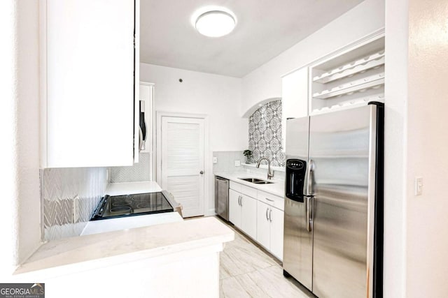 kitchen with a sink, white cabinetry, appliances with stainless steel finishes, backsplash, and open shelves