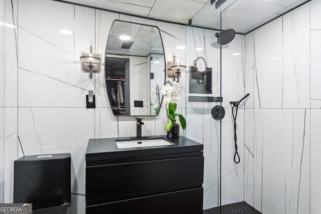 bathroom featuring vanity, tile walls, and a tile shower