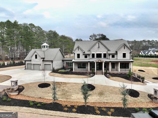 view of front of house featuring a garage and a porch