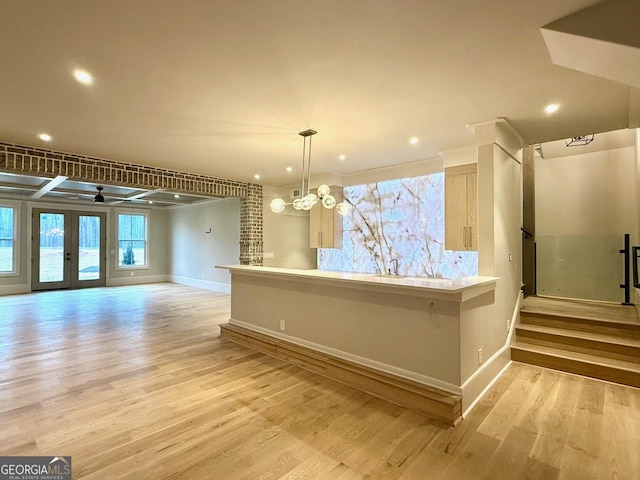 interior space featuring french doors, a notable chandelier, and light hardwood / wood-style flooring