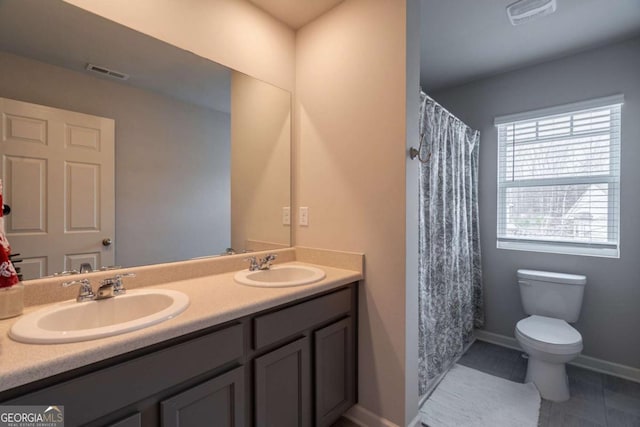 bathroom with tile patterned floors, vanity, and toilet