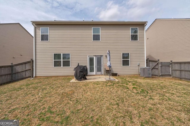 back of property with cooling unit, a patio, and a lawn