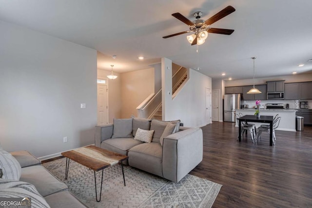 living room featuring dark hardwood / wood-style floors and ceiling fan