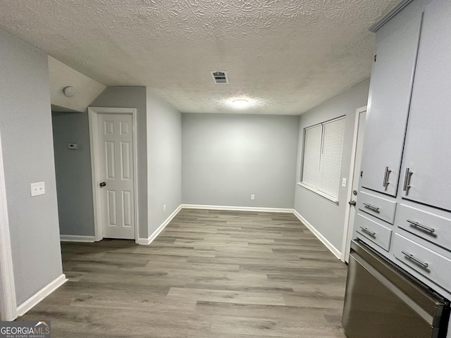 interior space featuring light hardwood / wood-style floors and a textured ceiling