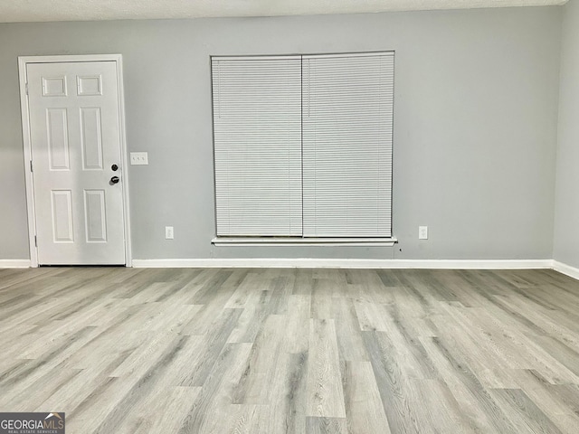 empty room with light hardwood / wood-style floors