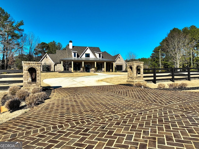 view of front of property with a fenced front yard and stone siding