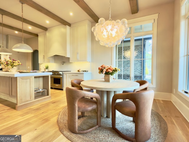 dining area featuring baseboards, light wood finished floors, beamed ceiling, and an inviting chandelier