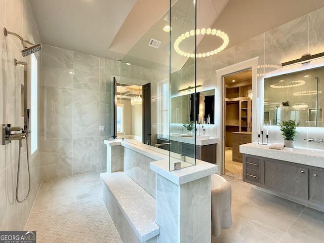 full bathroom featuring visible vents, a walk in shower, and tile walls