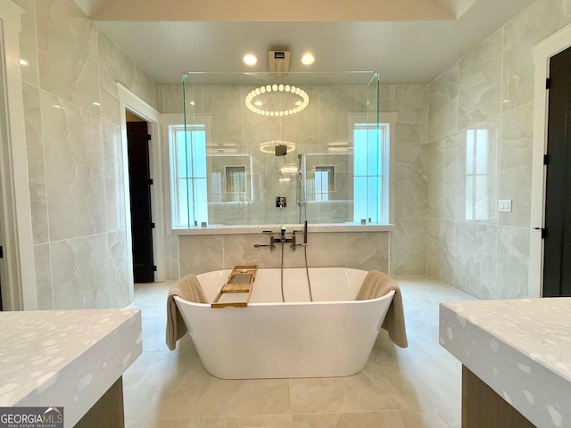 full bath featuring a soaking tub, tile walls, and a stall shower