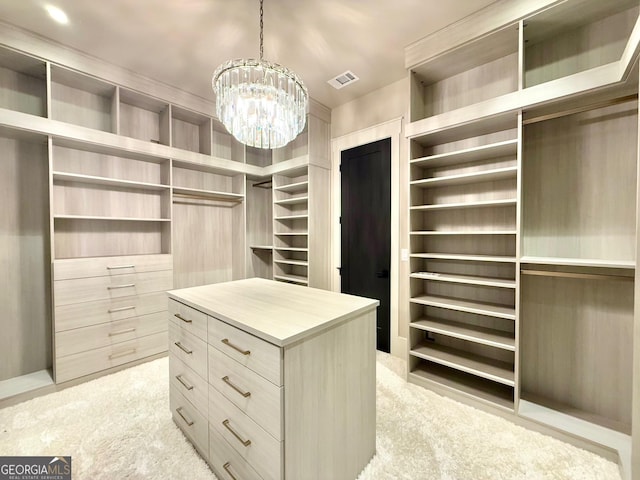 walk in closet with light carpet, visible vents, and a chandelier