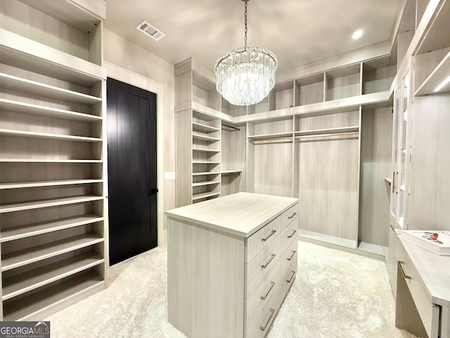 spacious closet featuring visible vents, a chandelier, and light colored carpet