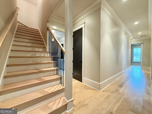 stairs featuring recessed lighting, wood finished floors, visible vents, baseboards, and crown molding